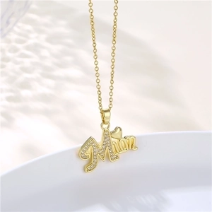 Detailed view of gold MOM pendant with cubic zirconia heart on stainless steel chain
