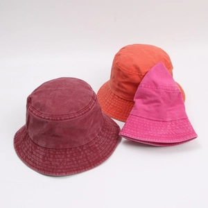 Vintage washed cotton bucket hats in dark red, orange, and rose pink for outdoors