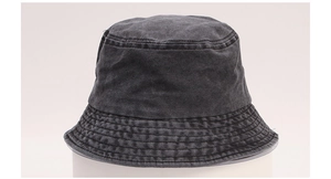 Close-up of vintage washed cotton texture and reinforced stitching on dark grey bucket hat