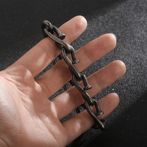 Detailed close-up of retro nail hook linked stainless steel chain bracelet on a hand