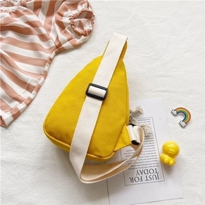 Detail of yellow canvas kids chest bag with adjustable strap and cute cartoon design