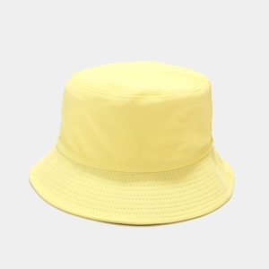 Detailed view of yellow cotton bucket hat with fine stitching on the brim detail