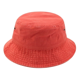 Detail of brick red washed cotton bucket hat showing metal eyelets and stitched brim