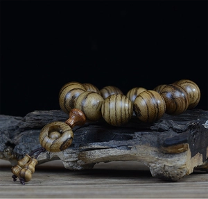 Detailed view of wooden beads with tiger-skin texture on natural wood base