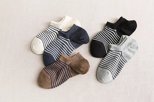 Flat lay of five pairs of men's striped low cut cotton socks in assorted colors