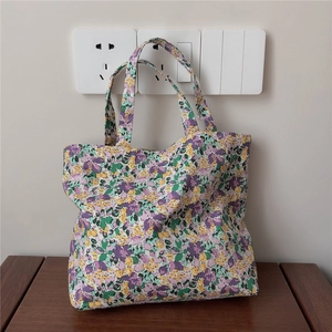 Detailed close-up of floral cotton tote bag with purple and yellow flower patterns