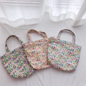 Detailed set of three floral canvas tote bags in purple, beige and light blue floral patterns