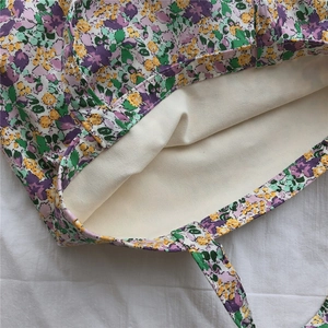 Detail of floral canvas tote bag showing thick beige cotton lining and double handles