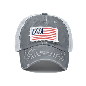 Close-up of distressed cotton baseball cap with American flag patch and white mesh