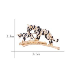 Detail of vintage tiger brooch with rhinestones and bamboo base, size 6.5cm by 3.3cm