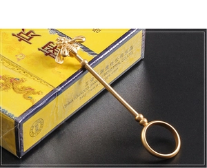 Detailed macro view of a golden bee-shaped cigarette holder ring made of high-quality alloy