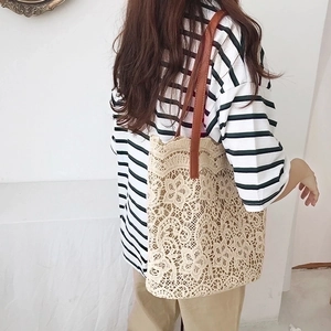 Beige floral lace crochet tote bag with brown leather shoulder straps for summer travel