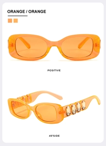Detail view of orange rectangular sunglasses featuring crystal-encrusted temples and frame