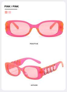 Pink narrow rectangle sunglasses featuring large crystal embellishments on the temples