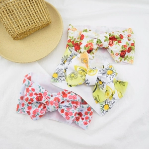 Detail of baby headbands featuring floral and lemon prints with large fabric bows