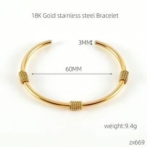Detail of 18K gold stainless steel C-shape bracelet with 60mm diameter and 3mm thickness