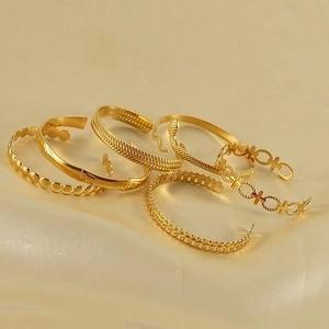 5-piece set of 18K gold plated stainless steel chain bracelets on champagne silk fabric