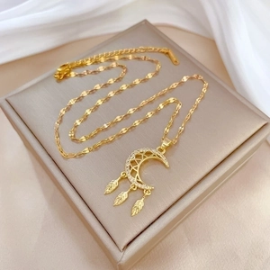 Luxury gold titanium crescent moon dreamcatcher necklace on jewelry box