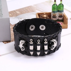 Detail of punk leather bracelet featuring silver metal skull and bullet stud accents
