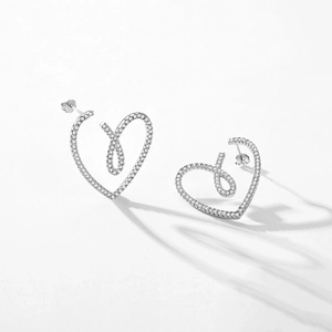 Minimalist S925 sterling silver heart earrings with micro-pave cubic zirconia on white background