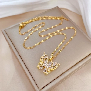 Luxurious gold butterfly necklace with crystal zircon inlays on a jewelry box