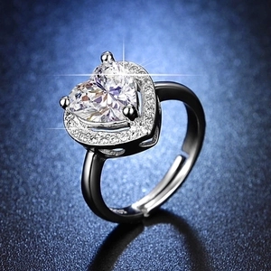 Detail of silver heart-shaped moissanite ring with six-prong setting and adjustable band