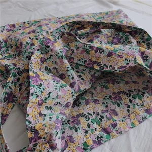 Detail of purple floral canvas tote bag showing the vintage flower pattern and texture