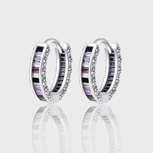 Macro detail of silver sterling hoop earrings with multi-color zircon stone inlays
