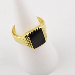 Macro shot of 18K gold plated stainless steel signet ring with black square stone inlay