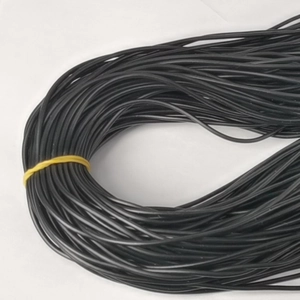 Close-up of black 1.5mm waxed cotton necklace cords bundled with a yellow tie cord