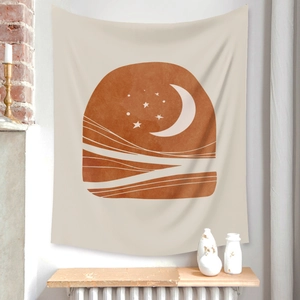 Detail of bohemian sun and moon tapestry hanging on a wall with warm terracotta tones