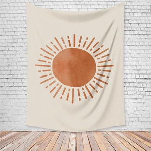 Detail of bohemian sun tapestry hanging on white wall showing fabric texture and design