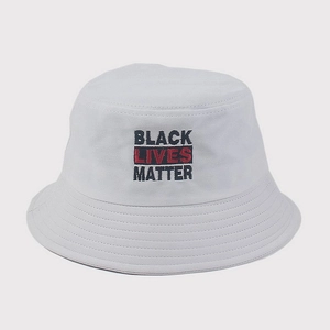 Detail showing high-quality black and red embroidery on a white cotton bucket hat