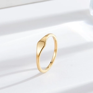 Minimalist gold titanium steel ring with an irregular flat top design and glossy finish