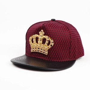 Detail of burgundy mesh snapback with gold crown metal badge and rhinestone accents