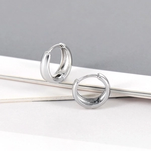 Elegant polished silver S925 huggie hoop earrings with a minimalist round metal design