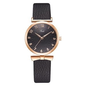 Détail du bracelet de montre en cuir noir avec boucle rose gold et attaches en nœud