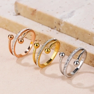Three minimalist spiral rings in gold, rose gold and silver with zircon accents