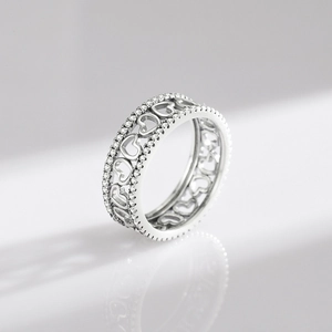 Vintage S925 sterling silver hollow heart ring with sparkling crystal inlay on white background
