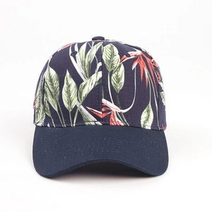 Detailed shot of navy baseball cap featuring vibrant tropical leaf and floral print patterns