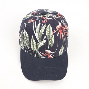 Detailed view of the dark blue baseball cap featuring tropical bird of paradise floral prints