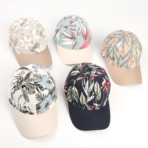 Detail of five baseball caps featuring vibrant tropical floral prints and contrast brims