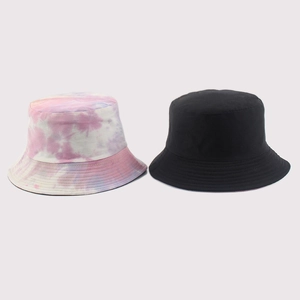 Detail of colorful tie-dye and black cotton bucket hats with reinforced stitched brims