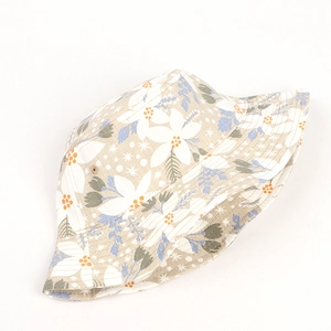Detail shot of the cotton fabric texture and floral print on the summer bucket hat