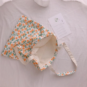 Detail view of cotton tote bag interior with citrus floral print and inner pocket