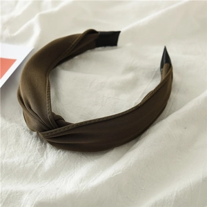 Detail of fabric knotted headband in brown and army green with soft woven texture
