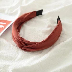 Detailed close-up of terracotta fabric headband with elegant knot and non-slip design