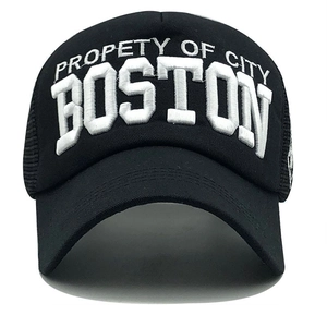 Detailed close-up of white 3D embroidery featuring Boston on black mesh trucker cap