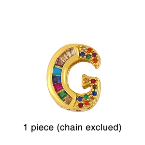 Detailed view of an 18K gold letter G pendant with multi-colored rectangular gemstones