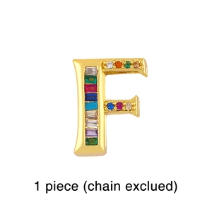 Detailed view of golden letter F pendant with colorful rainbow zircon stones inlay